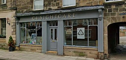 The C4 Sightcare shopfront at 65 Newgate Street, Morpeth, a slate-grey painted Georgian frontage with display windows